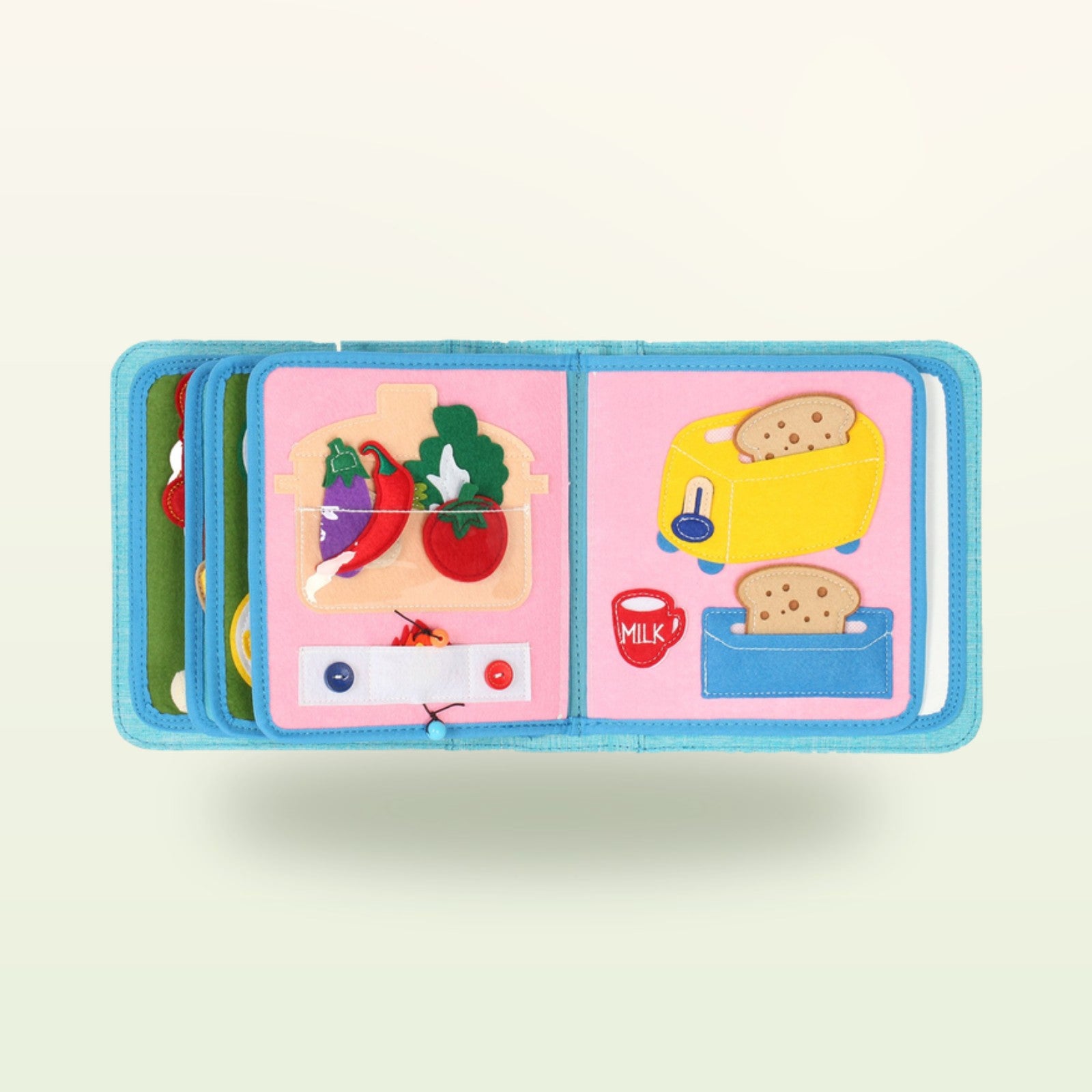 Kleine Feinschmecker Quiet Book Seite mit Filz-Gemüse im Topf und gelbem Toaster auf sanftem Creme-Hintergrund – ab 1 Jahr