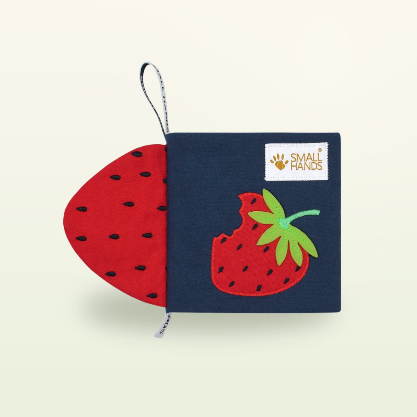Small Hands Bunte Früchte Montessori Stoffbuch – marineblauer Einband mit roter Erdbeere auf sanftem Creme-Hintergrund – ab 0 Monaten